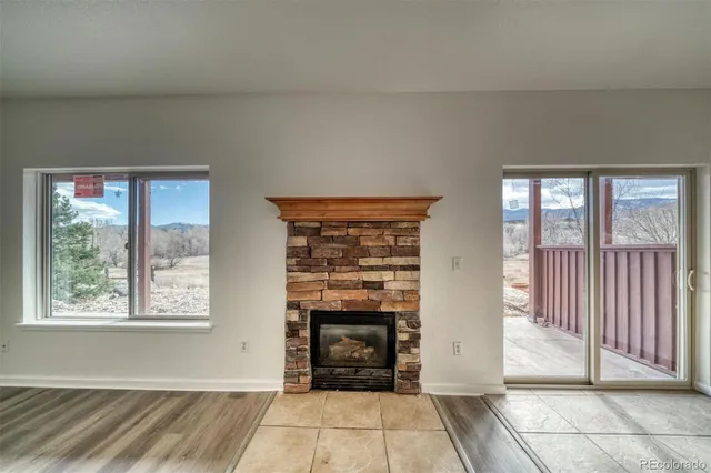 a view of a livingroom with entryway and an empty room