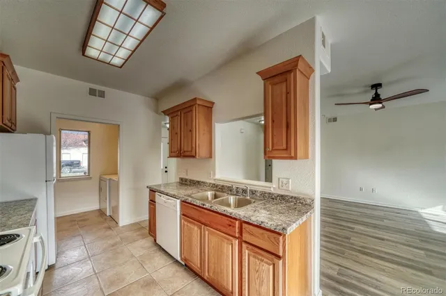 a kitchen with stainless steel appliances granite countertop a refrigerator and a stove