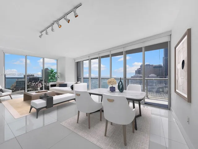 a very nice looking living room with a large window and a table