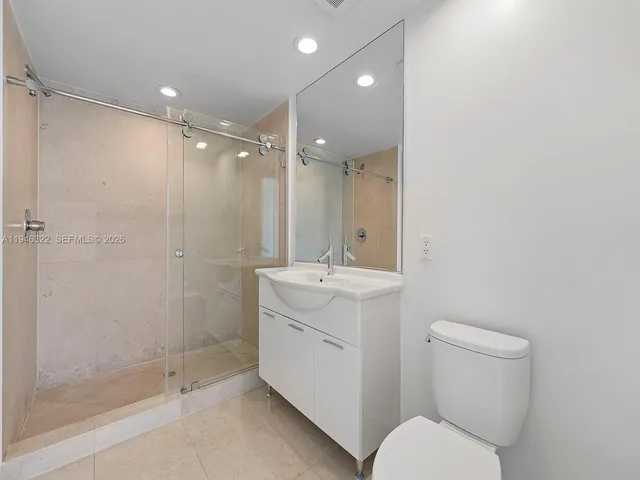 a bathroom with a toilet sink and shower