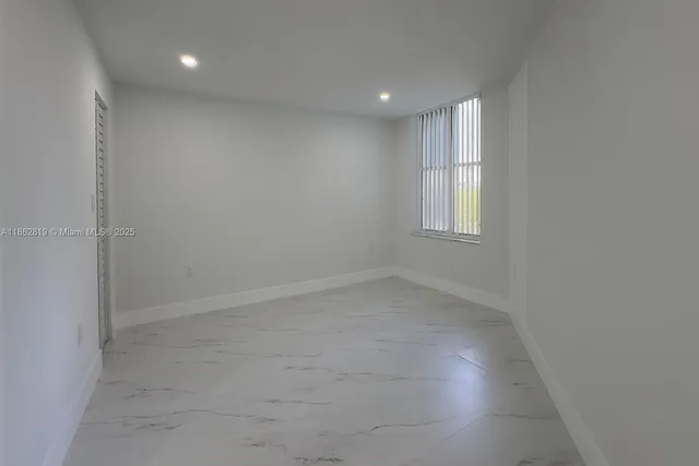 an empty room with windows and entrance