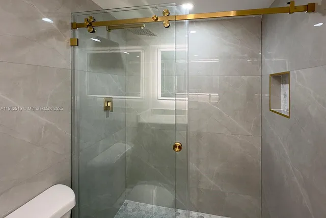 a bathroom with a shower and toilet