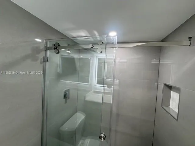 a bathroom with a glass shower door