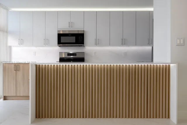 a kitchen with a sink and a microwave