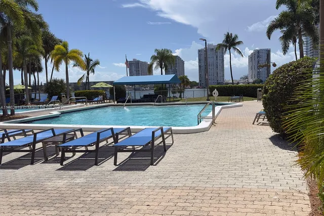 a view of swimming pool with outdoor seating