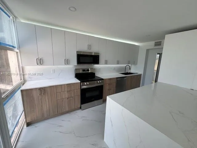 a kitchen with a sink a stove and refrigerator