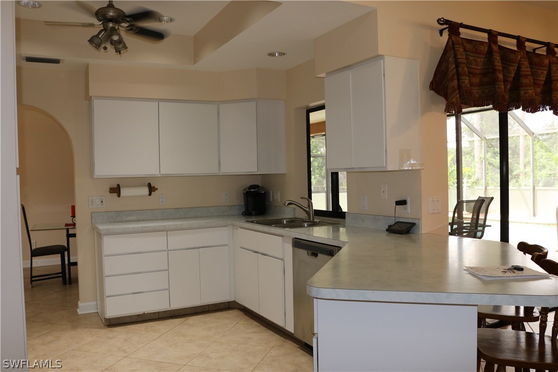 18432 Olive Road Fort Myers, FL 33967 - Photo 5 of 18 a kitchen with a sink a stove and cabinets
