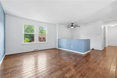 wooden floor in an empty room with a window