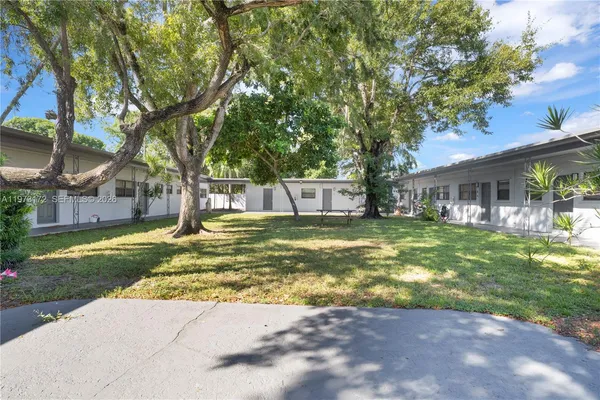 a view of a house with swimming pool and a big yard