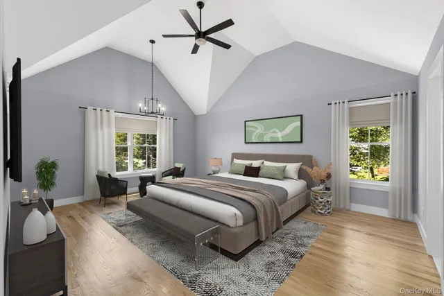 a spacious bedroom with a large bed and a chandelier
