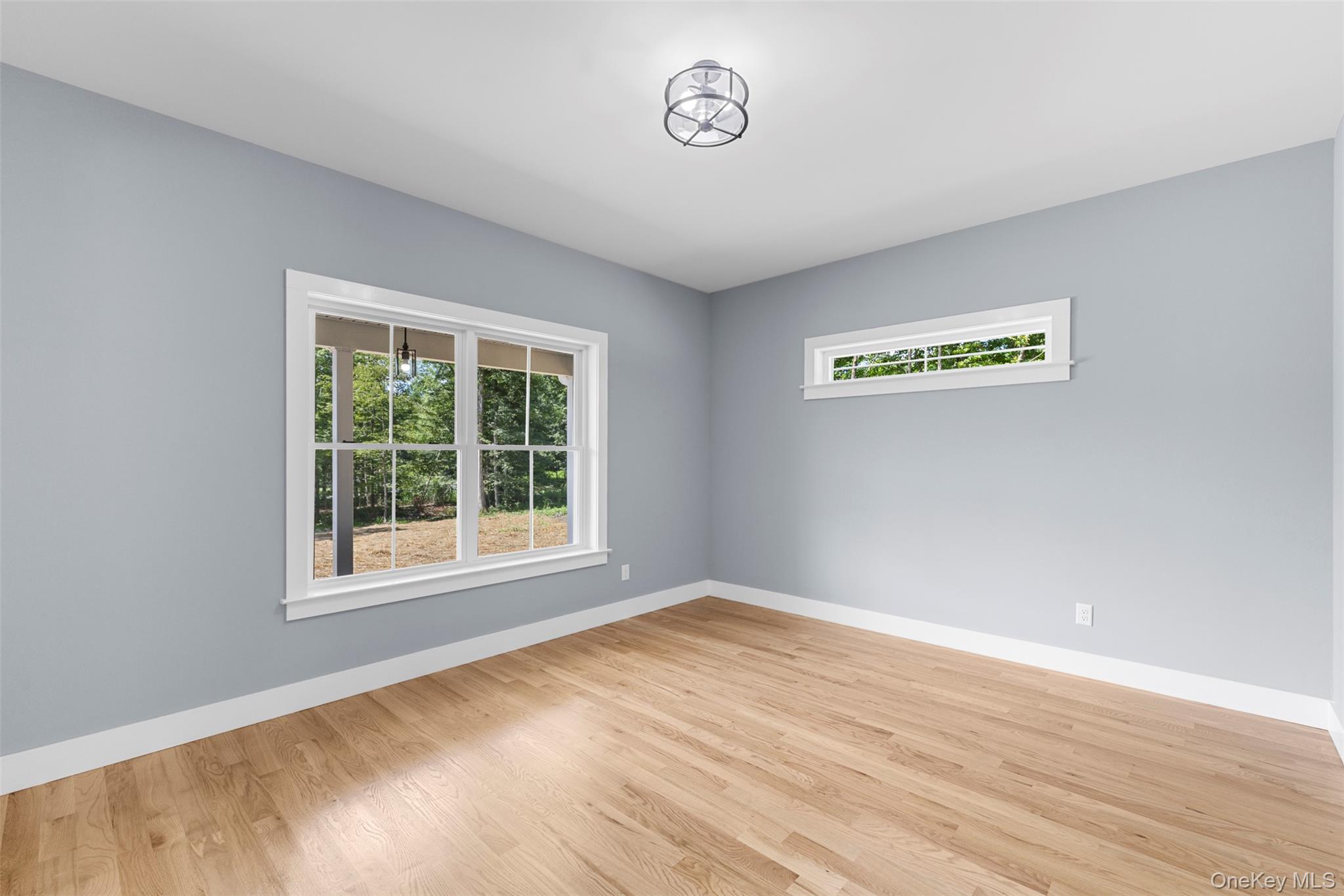 264 Lybolt Road Middletown, NY 10941 - Photo 28 of 45 a view of an empty room with wooden floor and a window