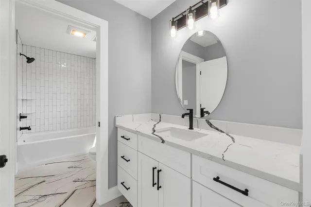 a bathroom with a sink a vanity and a mirror