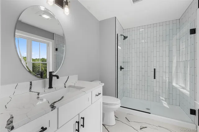 a bathroom with a sink toilet and shower