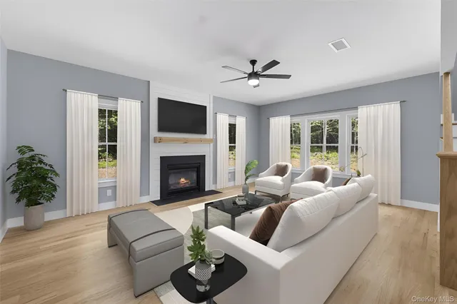 a living room with furniture a fireplace and a flat screen tv