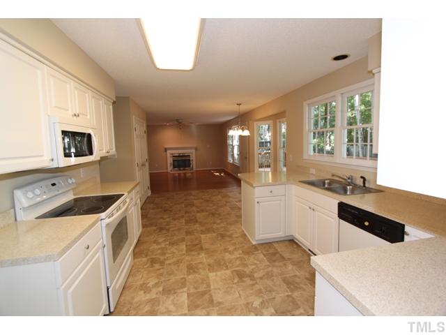 8500 Wheeling Drive Raleigh, NC 27615 - Photo 4 of 24 a large white kitchen with sink and window
