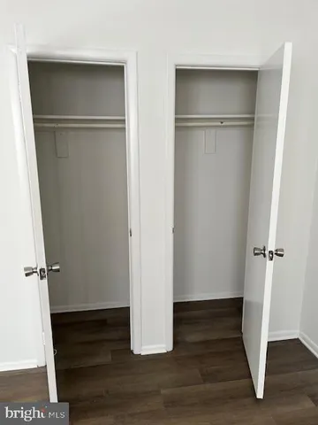 a view of walk in closet with wooden floor