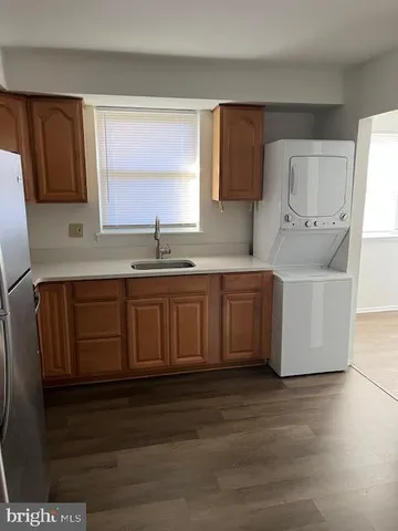 a kitchen with stainless steel appliances granite countertop a sink a stove and a refrigerator