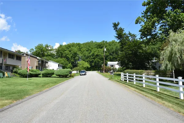 a view of a house with a yard and tree s
