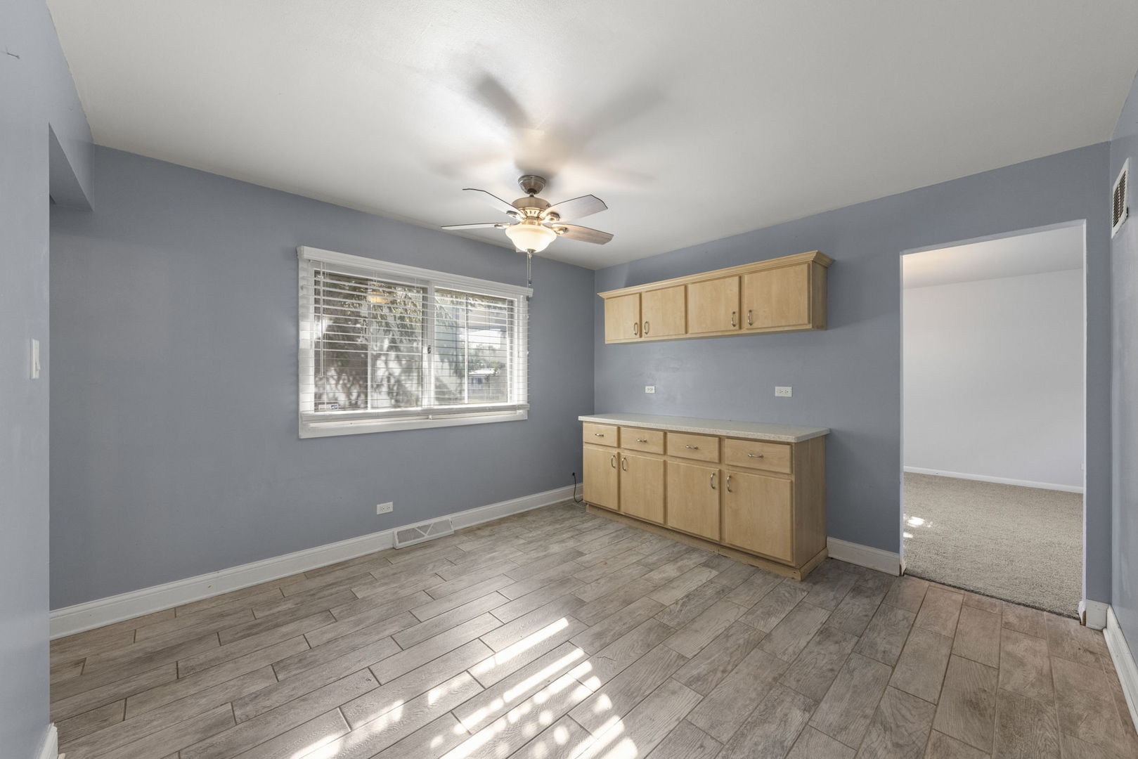 18749 Loomis Avenue Homewood, IL 60430 - Photo 7 of 41 a view of an empty room with a window and wooden floor