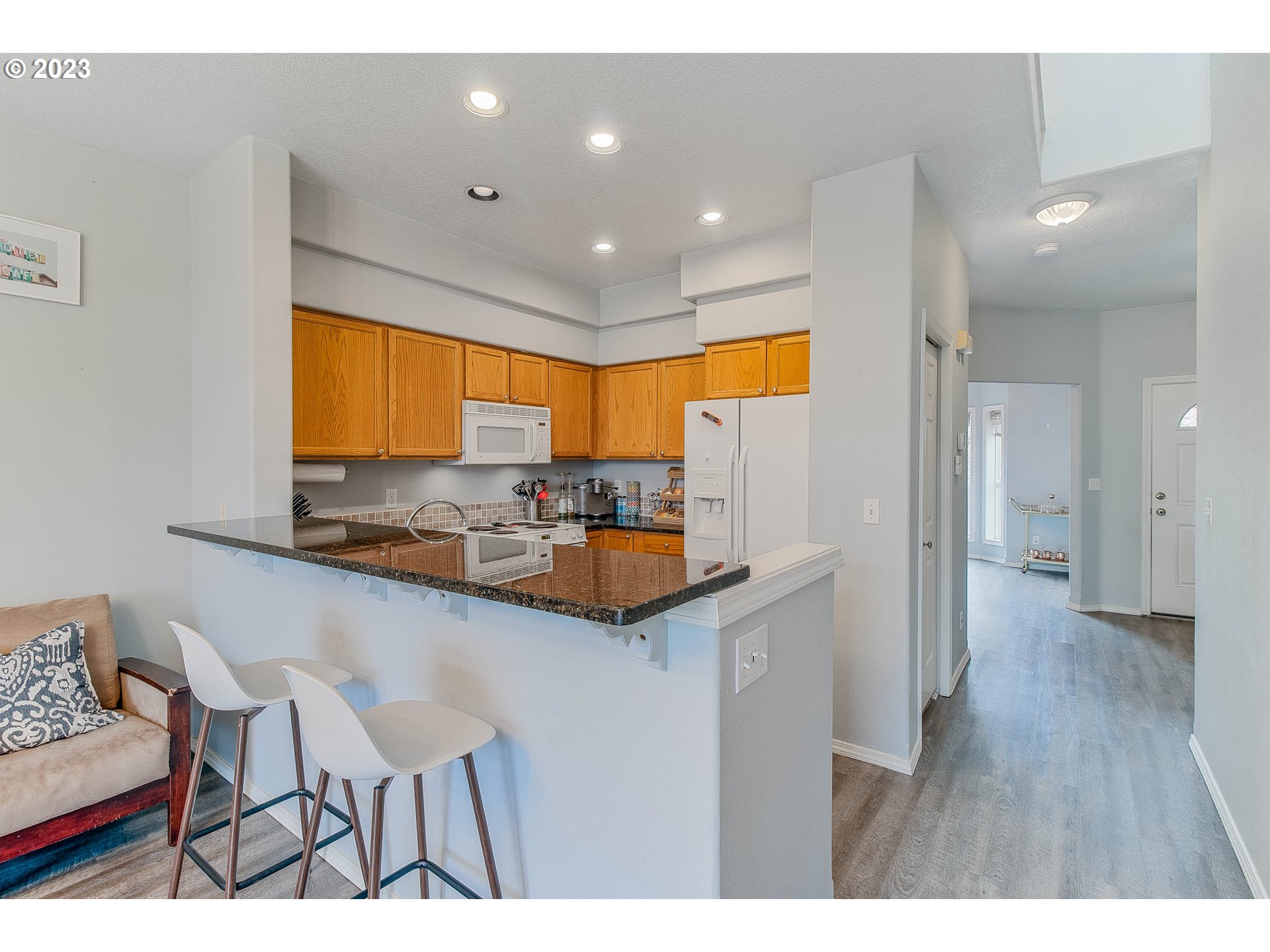 10335 Southwest Denney Road Beaverton, OR 97008 - Photo 11 of 31 a kitchen with stainless steel appliances granite countertop a sink and cabinets