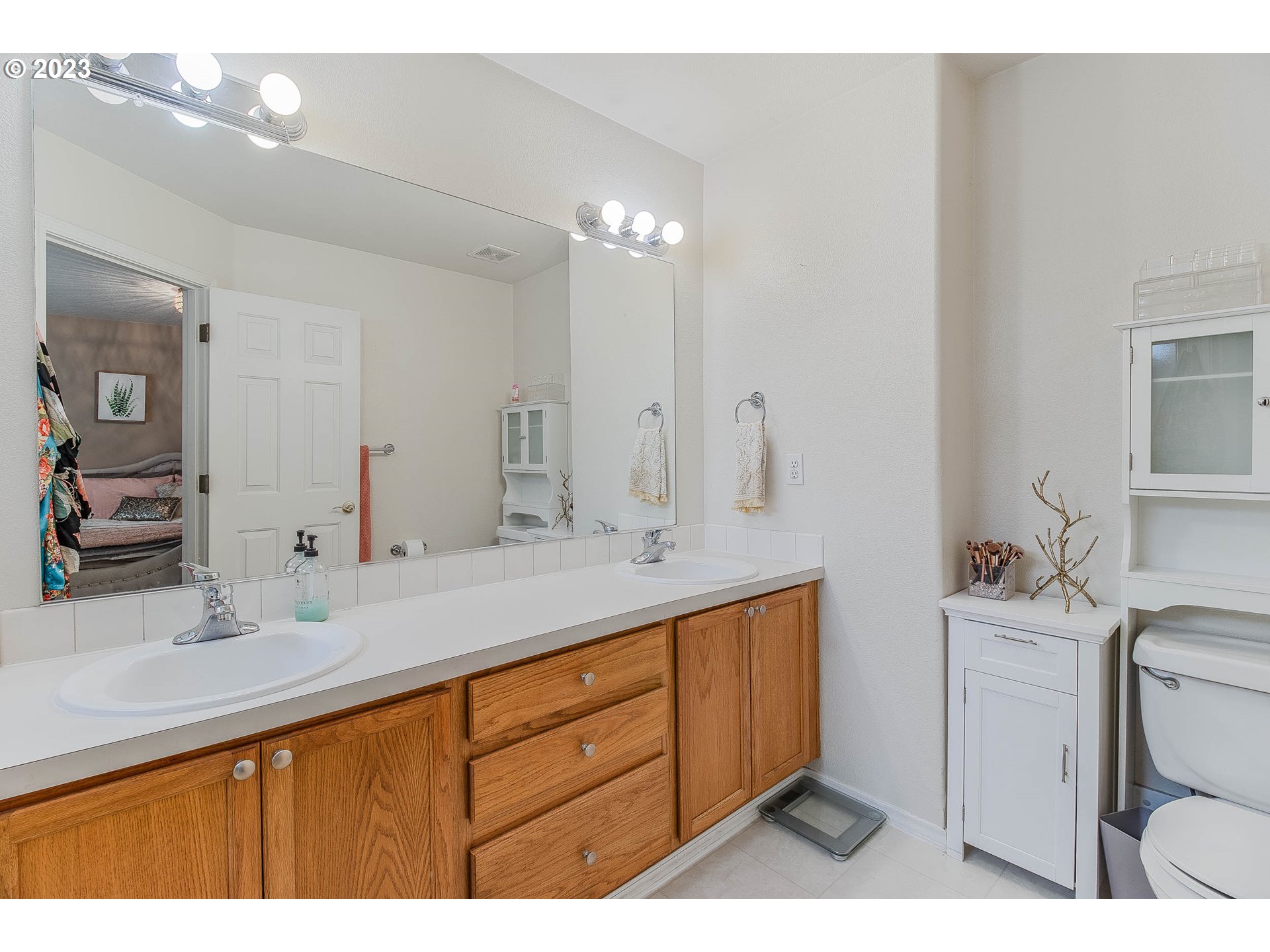 10335 Southwest Denney Road Beaverton, OR 97008 - Photo 21 of 31 a bathroom with a sink double vanity and a mirror