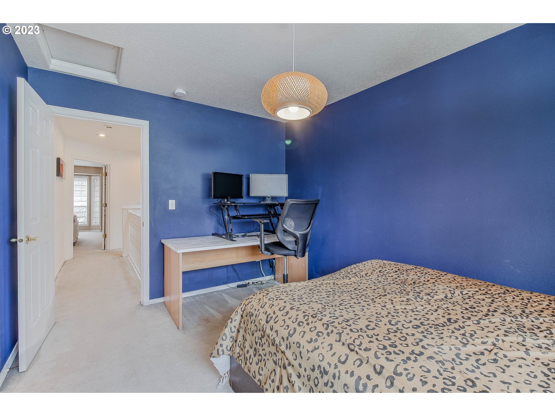 10335 Southwest Denney Road Beaverton, OR 97008 - Photo 23 of 31 a bedroom with bed and a chandelier