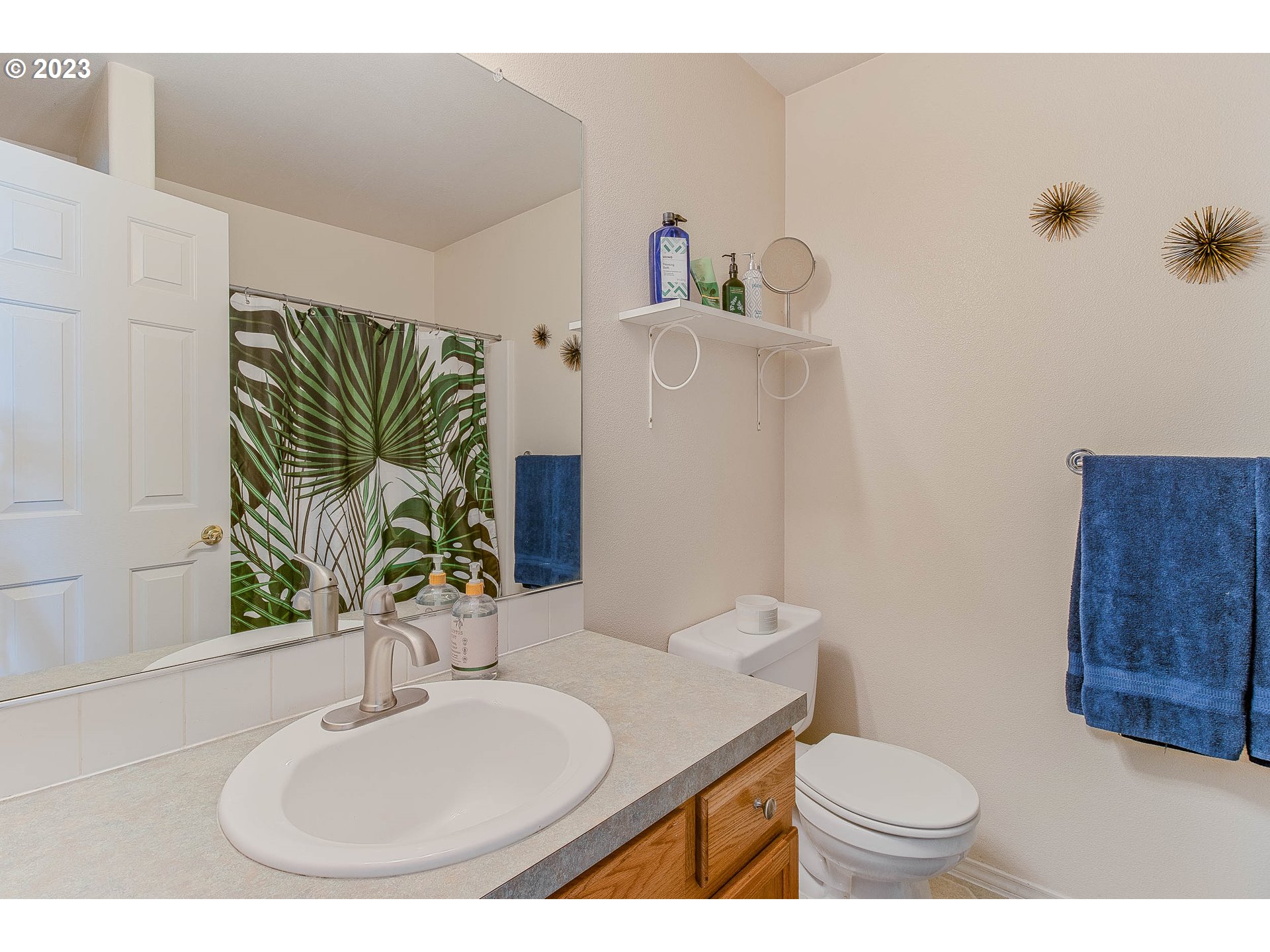 10335 Southwest Denney Road Beaverton, OR 97008 - Photo 24 of 31 a bathroom with a sink toilet and mirror