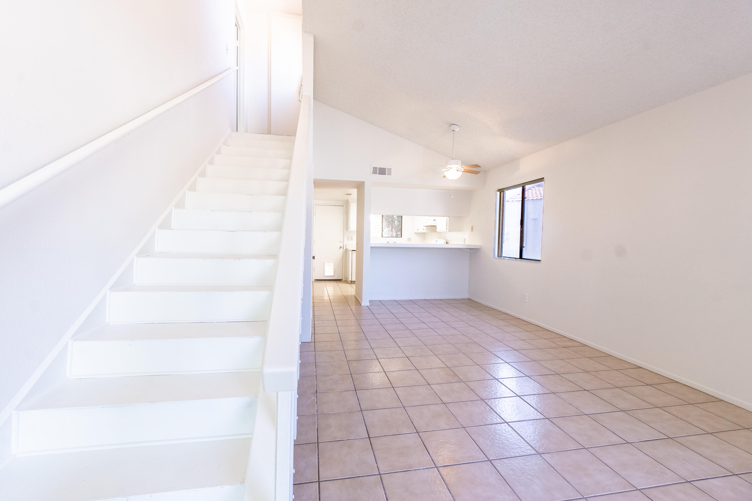 34334 Laura Way Rancho Mirage, CA 92270 - Photo 3 of 27 a view of an empty room with white walls and stairs