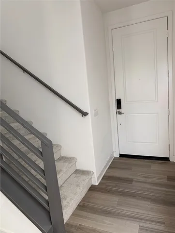 a view of an entryway with wooden floor