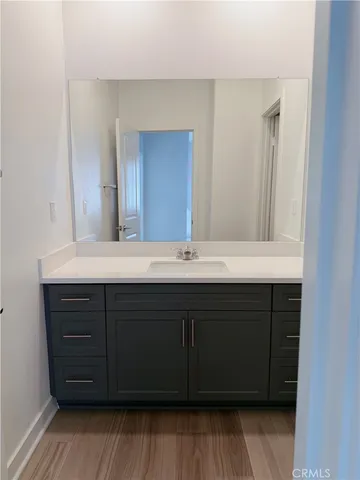 a bathroom with a sink vanity and a mirror