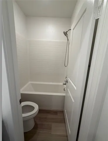 a bathroom with a toilet and a tub