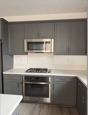 a kitchen with a stove and a microwave