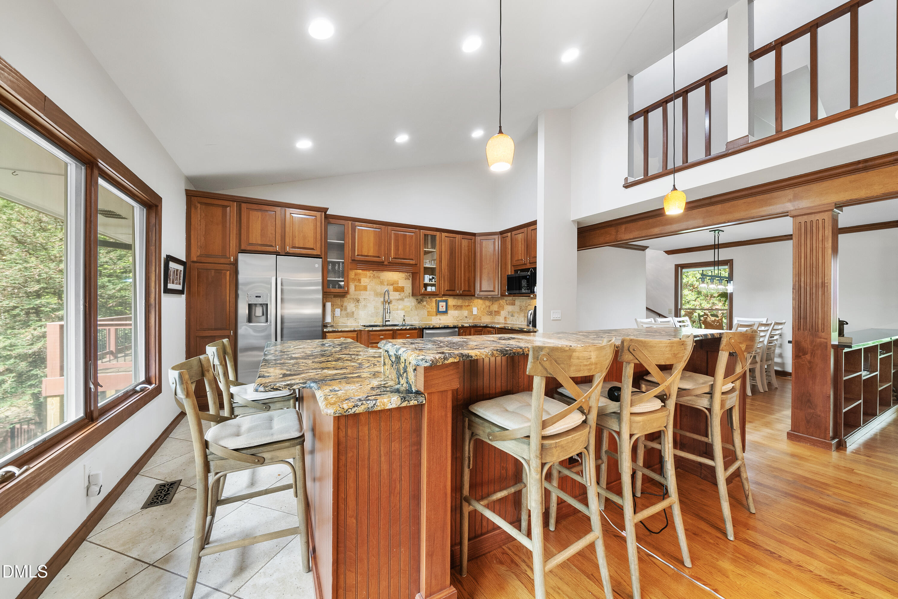 6200 Splitrock Trail Apex, NC 27539 - Photo 14 of 64 a kitchen with stainless steel appliances granite countertop table chairs and wooden floor