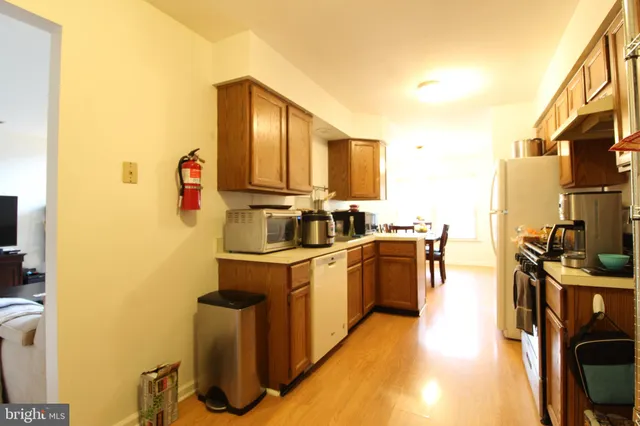 a kitchen with stainless steel appliances granite countertop a sink a stove and a refrigerator