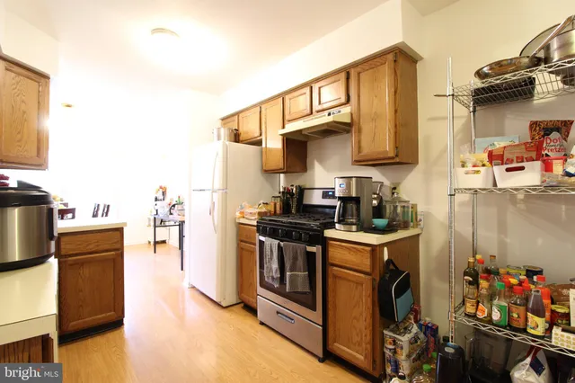 a kitchen with stainless steel appliances a stove a sink and a refrigerator