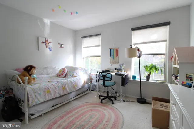 a bed room with bed and a chair