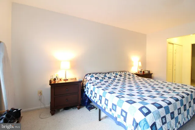 a bedroom with a bed and a lamp with window