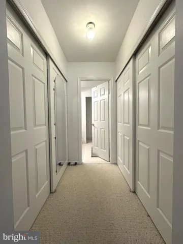 a view of a hallway with wooden shelves