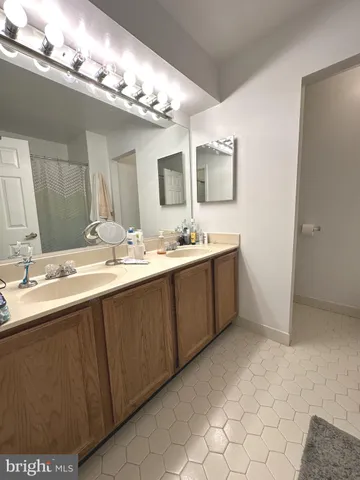 a bathroom with a double vanity sink and a mirror