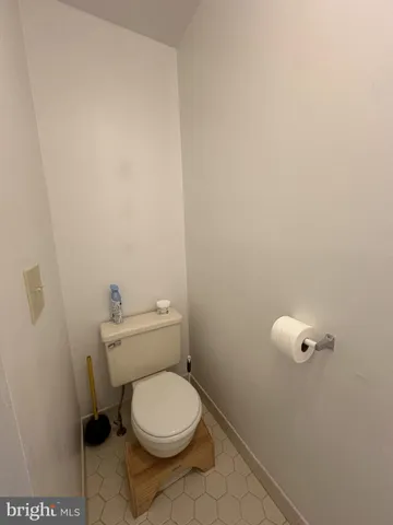 a white toilet sitting next to a shower