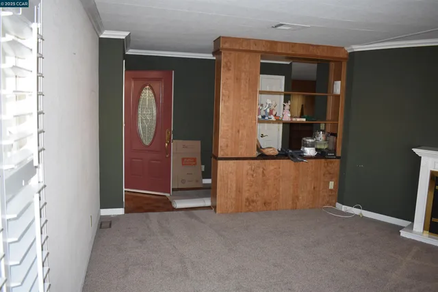 a view of a hallway with a fireplace and a window