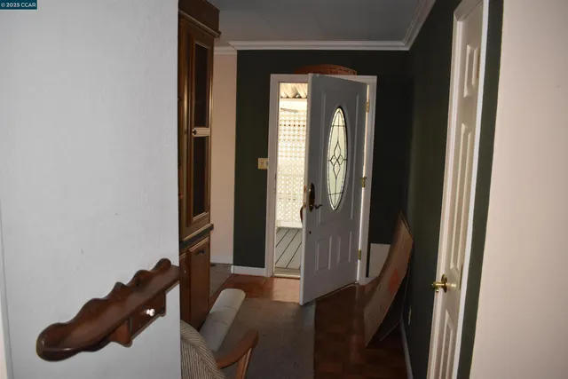 a view of a hallway with furniture and front door