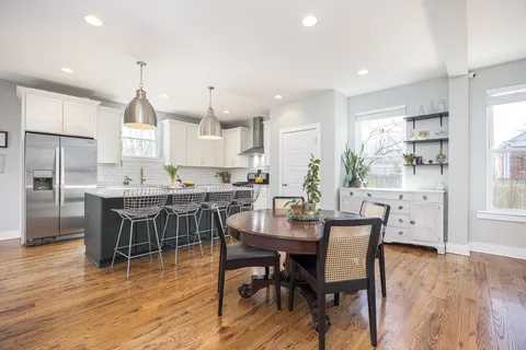 a front view of a house with a yard covered in snow