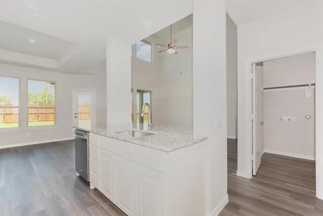 a view of bathroom with a sink mirror and wooden floor