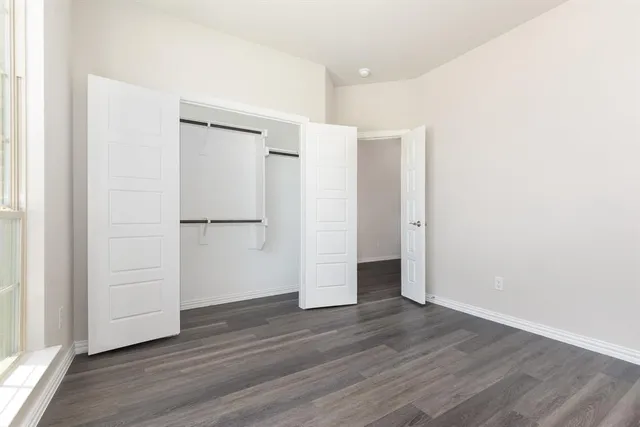 an empty room with wooden floor