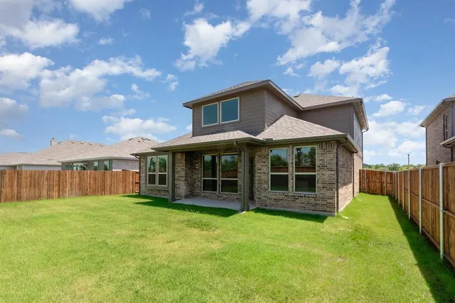 a view of a house with a yard and sitting area