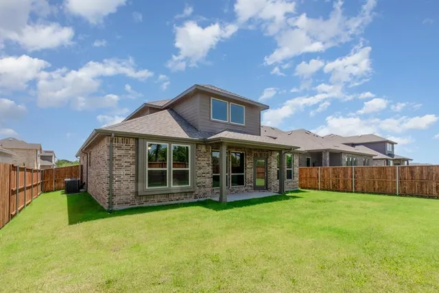 a view of a house with a yard and sitting area