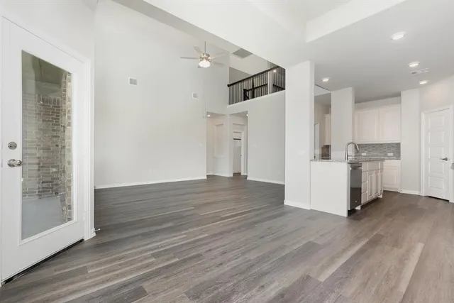a view of a kitchen with wooden floor and electronic appliances