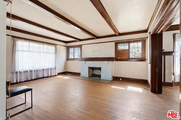 a view of a hallway with wooden floor and entryway