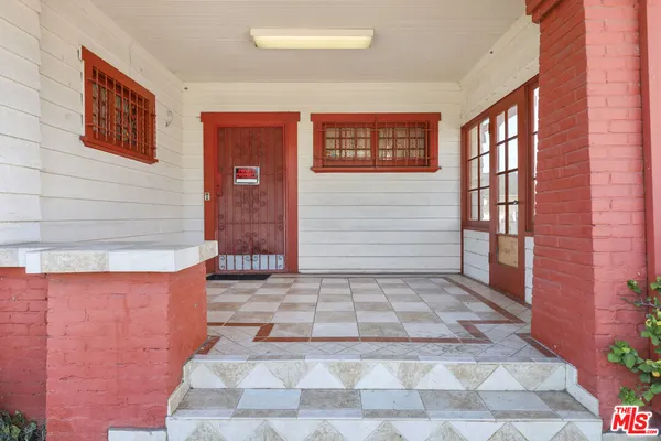 a view of staircase with wooden floor and white walls